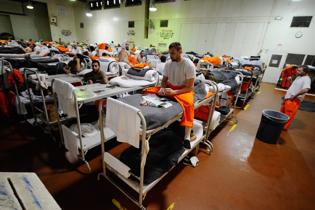 CHINO, CA - DECEMBER 10:  Inmates at Chino State Prison, which houses 5500 inmates, crowd around double and triple bunk beds at a gymnasium that was modified to house 213 prisoners on December 10, 2010 in Chino, California. The U.S. Supreme Court is preparing to hear arguments to appeal a federal courts ruling last year that the California state prison system would have to release 40,000 prisoners to cope with overcrowding so severe that it violated their human rights. More than 144,000 inmates are currently incarcerated in prisons that were designed to hold about 80,000.  (Photo by Kevork Djansezian/Getty Images)