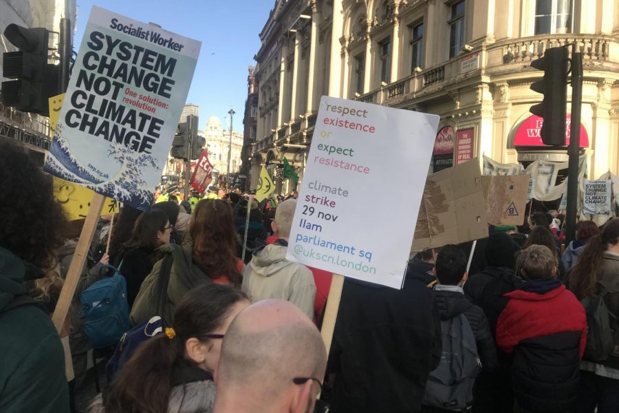 Protestors march along Shaftesbury Avenue on their way to Trafalgar Square on Friday, Nov. 22. Many of the protesters held posters with sayings such as “System Change not Climate Change” and “Planet not Profit.” 
