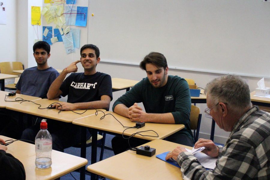 John Wilson prepares to ask a question in the quiz bowl semifinal between the team of Markos Glucksman (20), Smayam Bhavnani Thadani (‘20), and Yash Dhir (20) (right to left) and the team of Connor Eaton (‘21), Ethan Otero (‘21), and Rohit Venuturupalli (‘21). The final will take place during conference time in the school center Friday, Jan. 16.