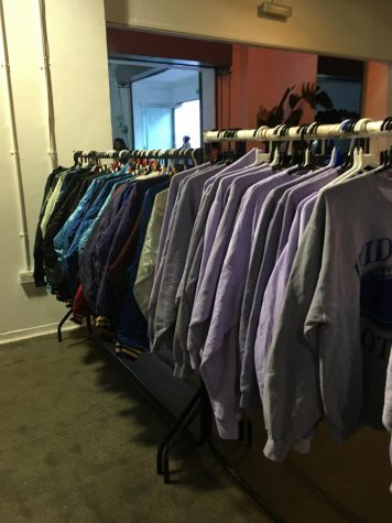 A rack at the Vintage Kilo Sale with clothes all with a similar style.