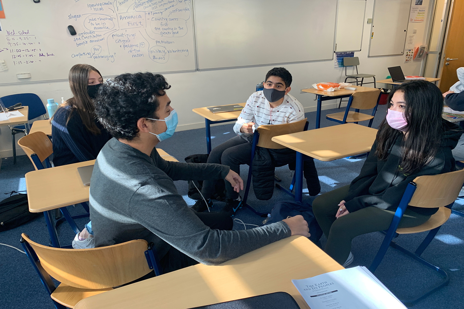 Samih Sawiris (’23), Emma Lucas (’23), Ana Costa (’23) and Ruhan Basin (’23)  discuss and debate the upcoming election in their World Civilizations II class.Social Studies classes have attempted to weave the election into curriculums and lessons to keep students informed. 