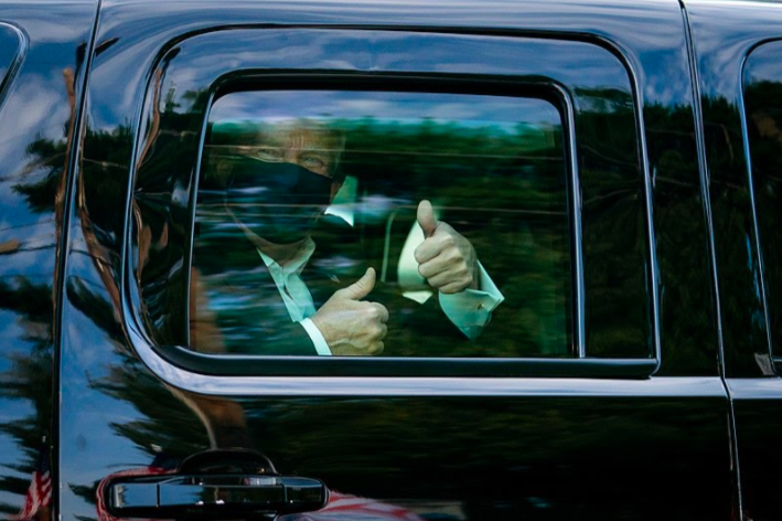 President Donald Trump greets supporters while driving outside the Walter Reed National Military Medical Center in Bethesda, Maryland. Trump was transferred to the hospital Oct. 2 after testing positive for COVID-19. 