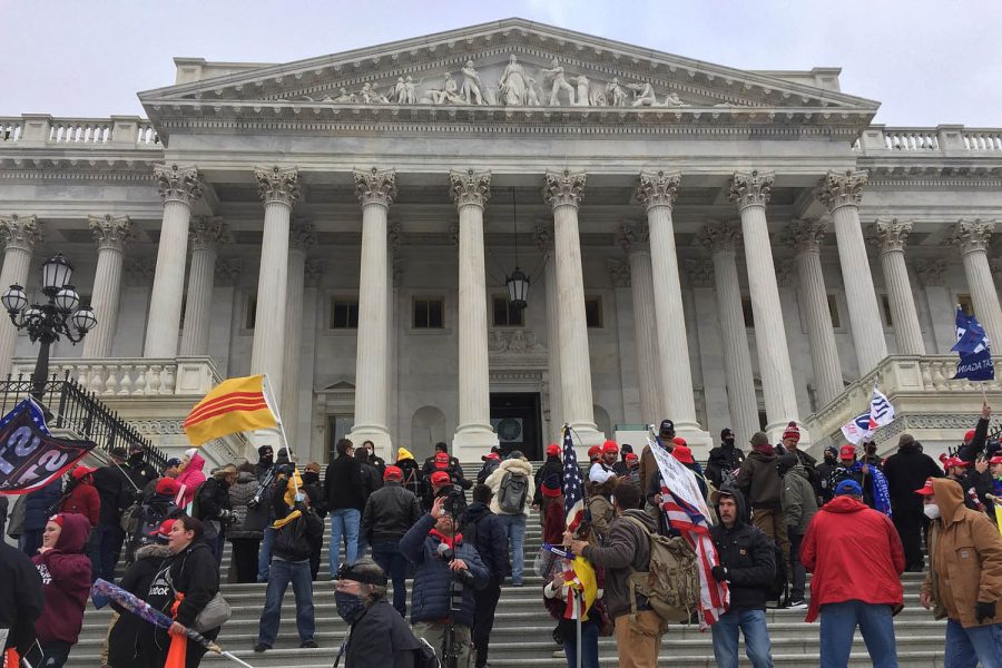 Pro-Trump rioters assemble outside the U.S. Capitol Jan. 6 to protest the certification of Biden’s win after false accusations of a fraudulent election conspired. Four civilians and a Capitol police officer were killed when the protest turned violent.