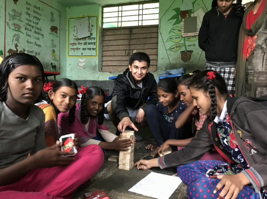 Arhan Sarma (’22) plays games with school children from the Sonkheda Village in 2019. He said he made many Meaningful connections with the children he worked with.