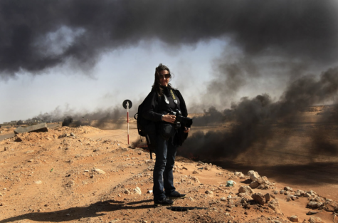 Photographer Lynsey Addario stands near the frontline during a pause in the fighting while covering the popular uprising for The New York Times, March 11, 2011 in Ras Lanuf, Libya.