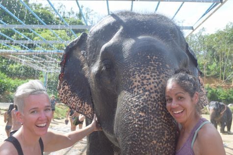 Science Teacher Alpha Toothman (right) and her wife pose with an elephant in the Phuket Elephant Sanctuary in Thailand November 2017. One of Toothman’s favorite activities is traveling the world with her wife.