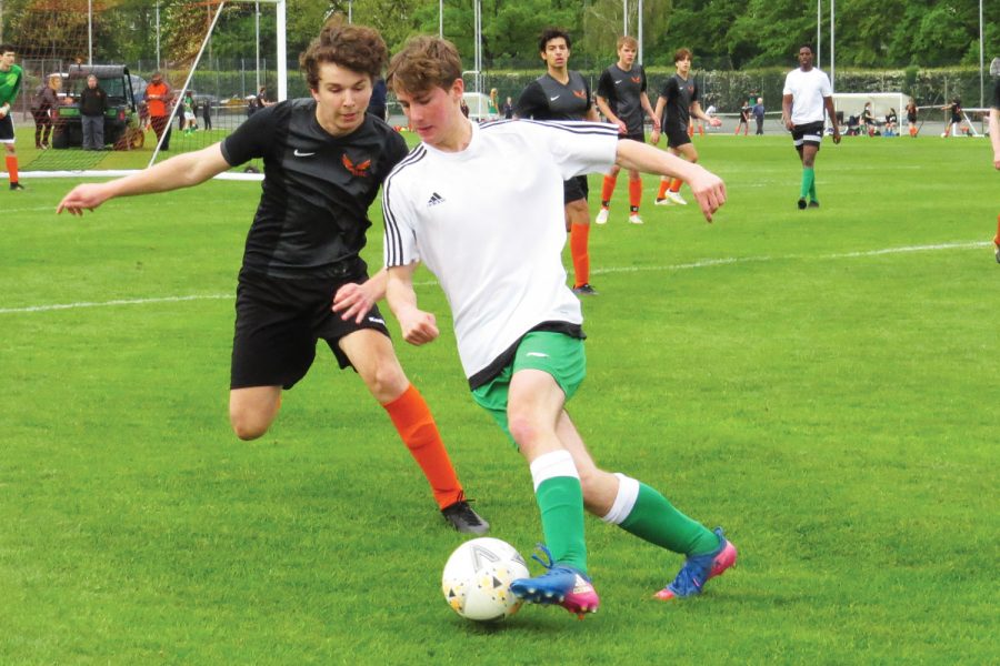 Max van Zyl (’21) attempts to steal the ball from an opponent during the varsity boys’ game against Cobham May 26. Cobham defeated ASL 3-0 in ASL’s last game of the season.