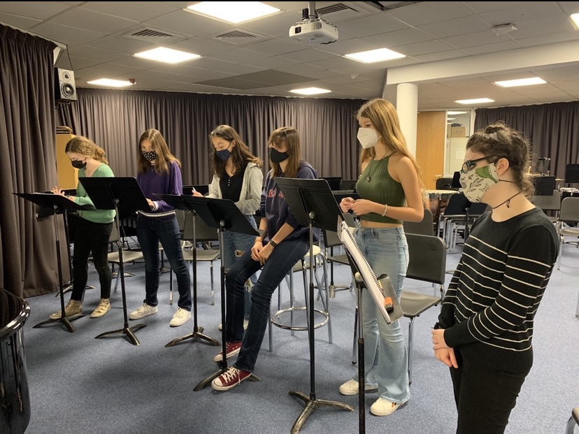 Footloose cast members practice choral arrangements during rehearsals. Performers have practiced for the past month in preparation for opening night Nov. 17.