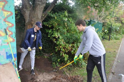 Jack Cutler (’22) and Leyth Sousou (’22) shovel dirt and rake away leaves in order to set up fencing at Pace Fortune Green for Community Volunteer Day Oct. 17. ASL families volunteered at 13 different community volunteer sites on the day. 