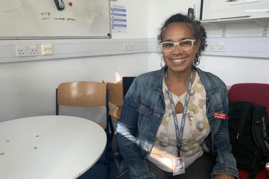 Yulisa Cruz smiles in her office, with the sun coming through the window. Cruz said her goal for this year is to build understanding between teachers and students. 