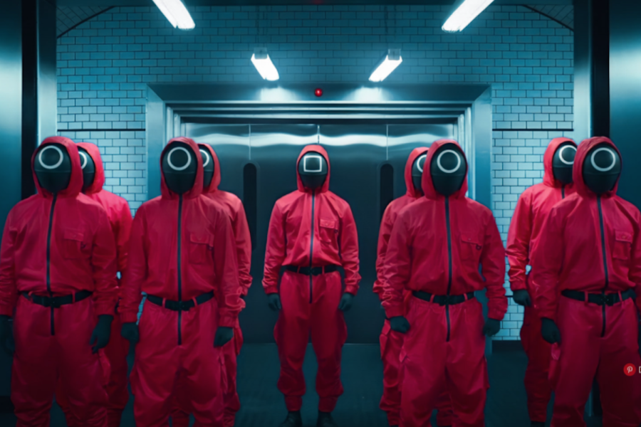 Pink masked soldiers assemble in rows in preparation for one of the many dangerous trials in the Netflix show “Squid Game,” released Sept. 17. The masked soldiers have become a symbol of the acclaimed program on social media platforms following its rapid rise to popularity.