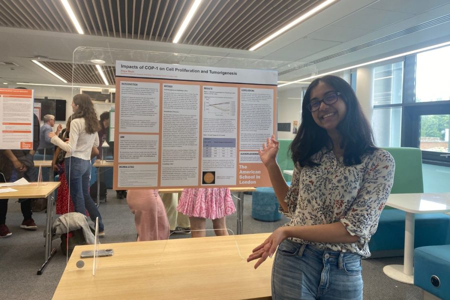 Priya+Shah+%28%E2%80%9922%29+presents+her+Advanced+Independent+Research+Colloquium+poster+at+the+Research+Symposium+June+7.+Throughout+the+research+process%2C+she+overcame+challenges+and+experienced+highlights+before+presenting+the+cancer+research+project+she+conducted+to+students+and+faculty.%0A