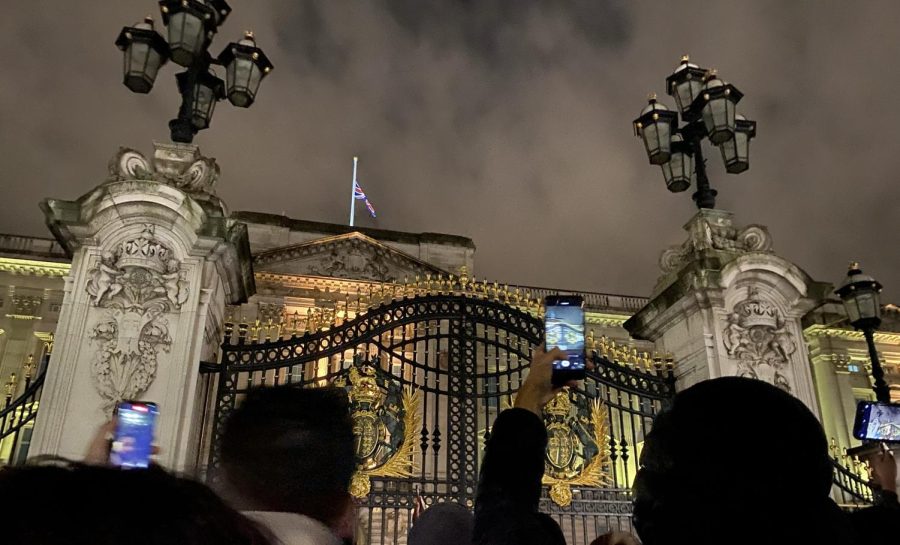 Two hours after the public announcement of the Queen’s death Sept. 8, crowds gather in front of Buckingham Palace backdropped by a flag lowered to half-mast. The official notice from the Royal administration consisted of two sentences posted on the gates as a double rainbow framed the Palace.