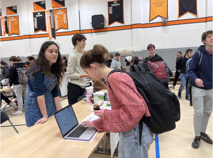 During the club fair Sept. 30, Sophia Iannazzo (’25) signs up for Graphic Design Club, led by Trixie Menegakis (’25). 

Menegakis said the graphic design classes she took last year inspired her to form the club so students have the freedom to choose their projects while improving design abilities.  

“It’s a place to work on your digital design skills,” Menegakis said. “We might make some posters, stickers or a book.”