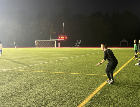 New varsity boys soccer coach Danny Cook instructs players from the sidelines at the International School of Brussels Oct. 16. The team won against the International School of Brussels. 