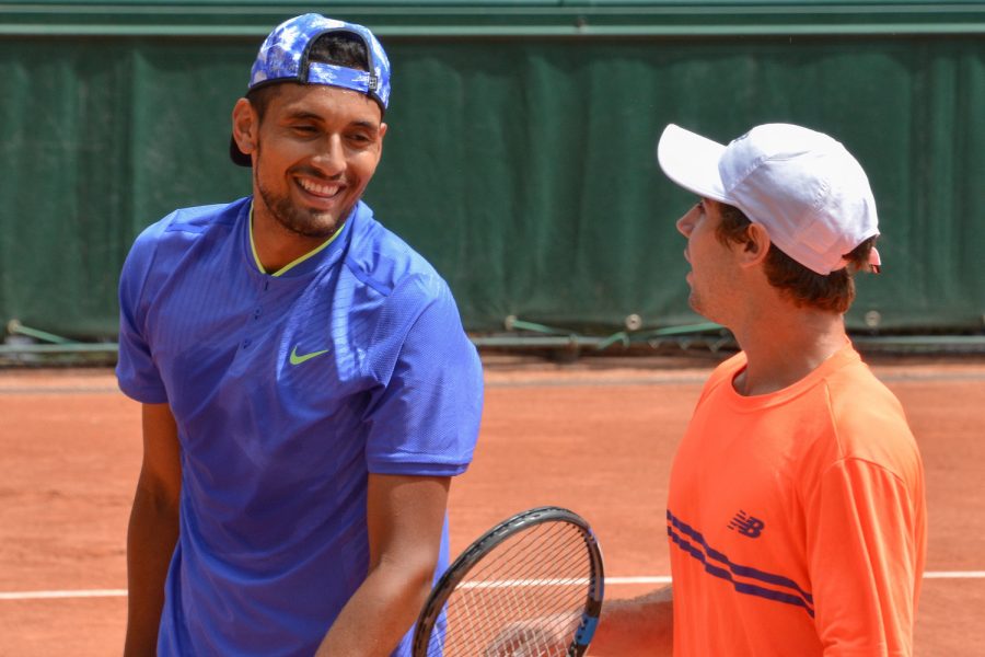 Nick Kyrgios practices alongside fellow Australian tennis player Jordan Thompson at Roland Garros in 2017. Kyrgios is known for his unorthodox style, and he gained traction after uncharacteristic wins during the 2022 season. 