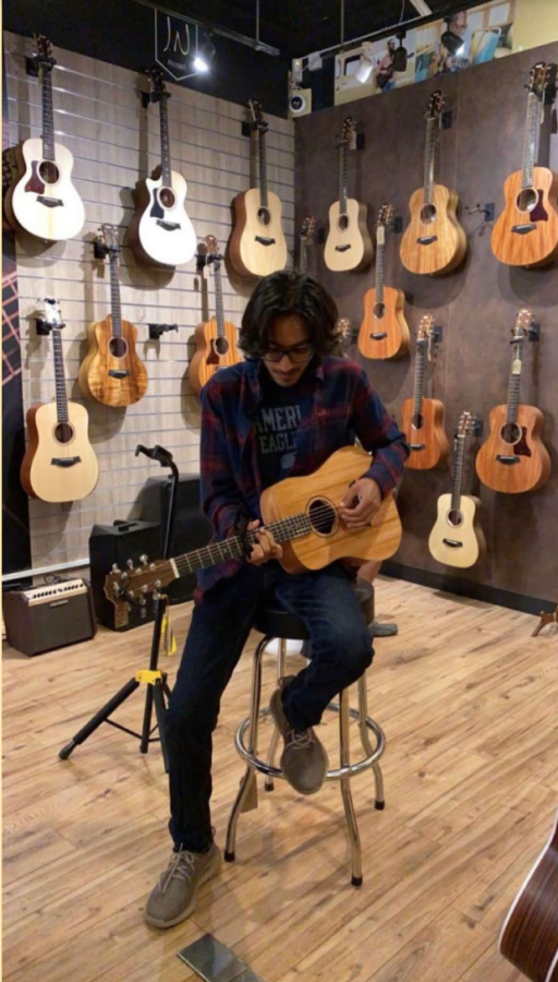 Gus Bhatia (’25) tries out different guitars in a store. Bhatia started playing guitar when he was younger and has learned to play additional instruments such as the bass guitar, piano and tabla.
