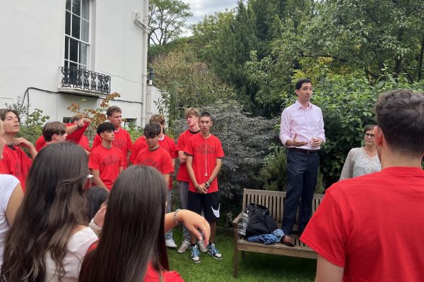 Interim High School Principal Jack Phillips delivers a speech to Grade 12 students in Bruce House Garden Aug. 24. At the gathering, food and drinks were provided as students mingled and received their red senior shirts.