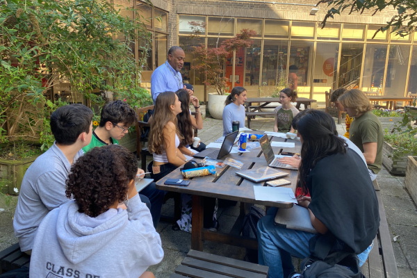 Director of Student Life Royce Wallaces advisory convenes outside to discuss upcoming activities as well as reflect on their back-to-school experience. Wallace introduced the Student Advisory Council as one of his first actions since taking on the Director role this school year. 