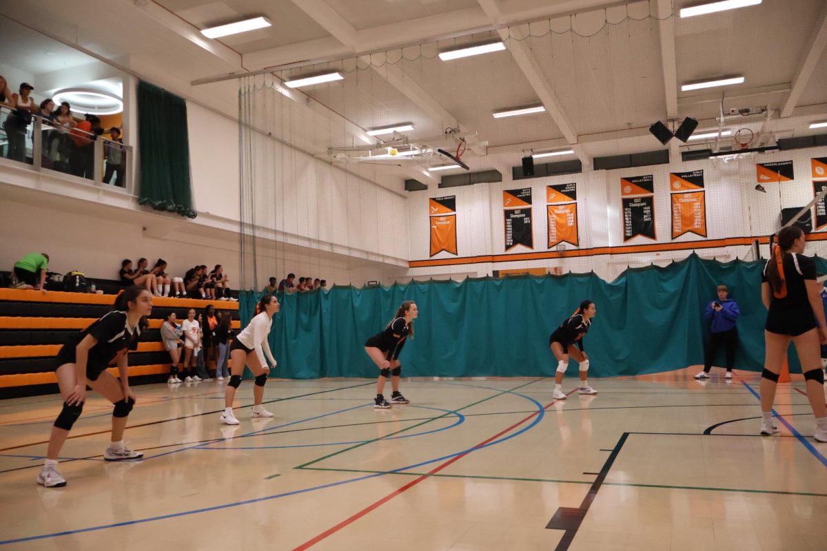 Girls+varsity+volleyball+players+Goksu+Manav+%28%E2%80%9927%29%2C+Lily+Rose+%28%E2%80%9926%29%2C+Gemma+Algard+%28%E2%80%9927%29+and+Sana+Ekroth+%28%E2%80%9926%29+are+ready+in+position+waiting+for+the+other+team+to+serve+in+a+game+against+The+American+School+of+Paris.+The+game+ended+in+a+2-1+loss+for+ASL+Sept.+29.