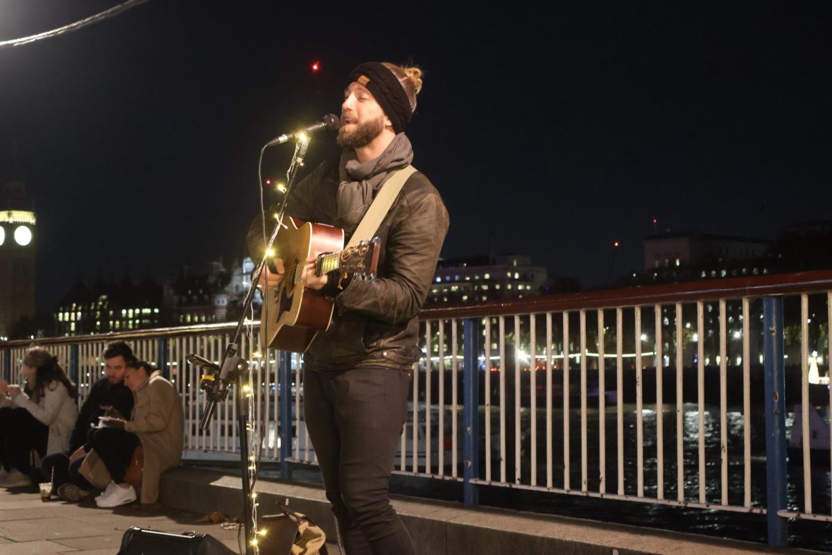 Brad Jameston performs original song “Dance in Your Fire” at the South Bank Nov. 23 2023. Jameston began performing his music in London after busking around Europe.