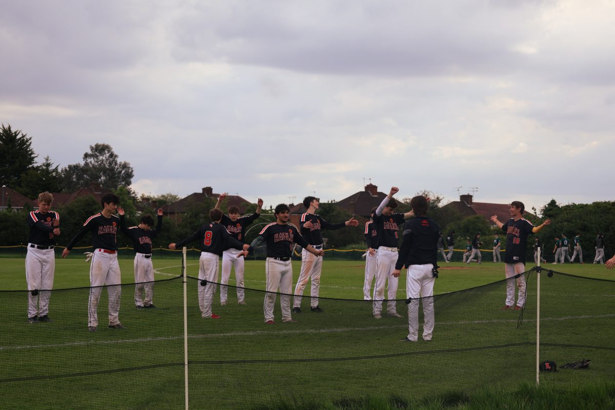 The varsity baseball team warms up for their ISST tournament May 24. The team won ISSTs by winning all four games they played.